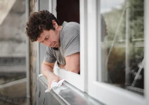 caucasian-man-cleans-window-frames-outside-2022-12-10-01-08-17-utc-1