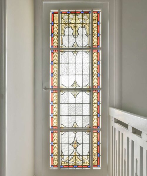 Spacious bright stained glass window with beautiful painted patterns